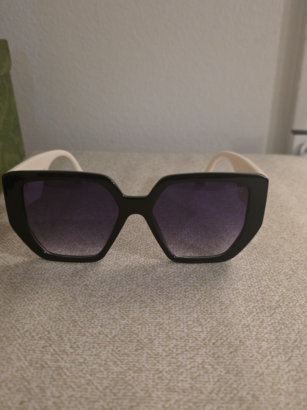 Gucci Women's Black Frame Sunglasses with Purple Lenses and Cream Temples